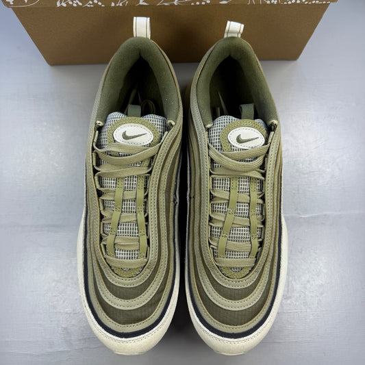 Nike trainers green with light bone accents and Air Max cushioning design.