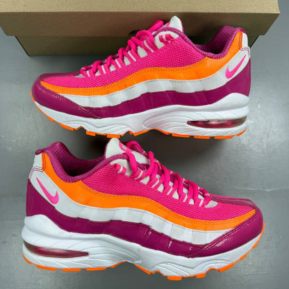 Nike running shoes vivid pink and white with mesh upper and Air Max cushioning.