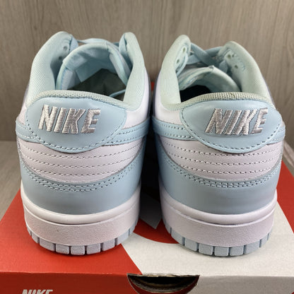 Nike Dunk Low Retro trainers glacier blue with white swoosh logo and textured material.