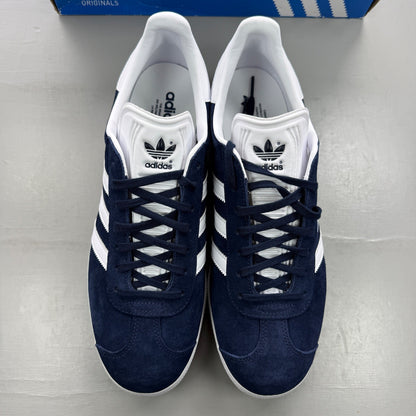 Adidas blue suede trainers with white stripes and logo detail.