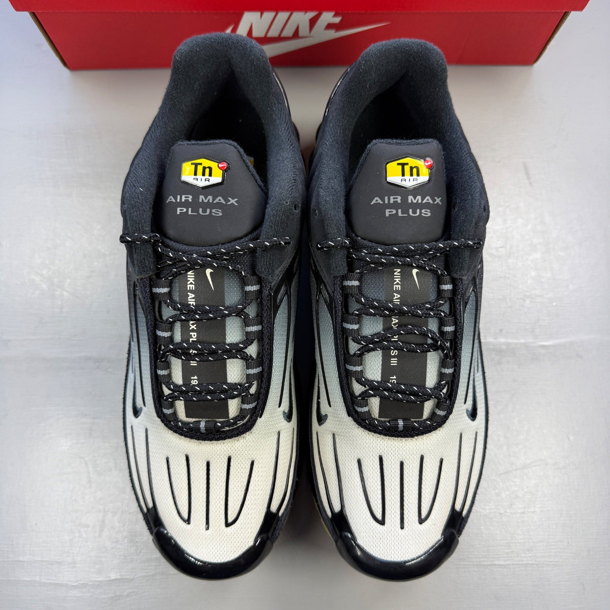 Nike deck shoes black with grey accents and gum sole, featuring iconic logo.