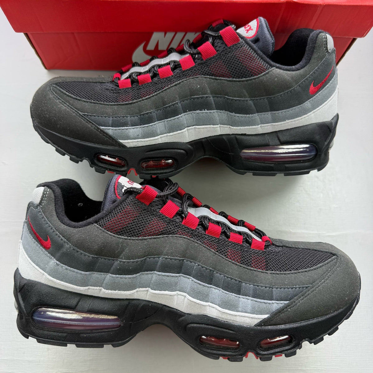 Nike Air Max 95 black trainers with Liverpool FC logo and big bubble sole.