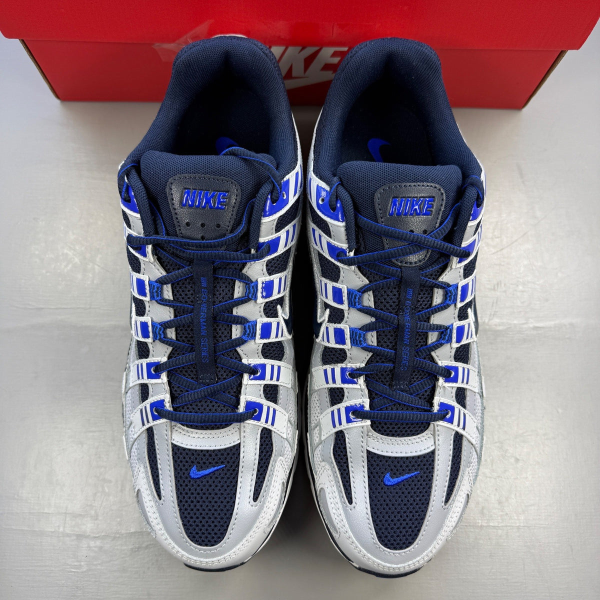 Nike deck shoes grey with blue eclipse accents and white sole, featuring logo detail.