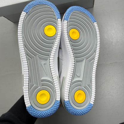 Nike Air Force 1 React white trainers with smoke grey accents and logo details.
