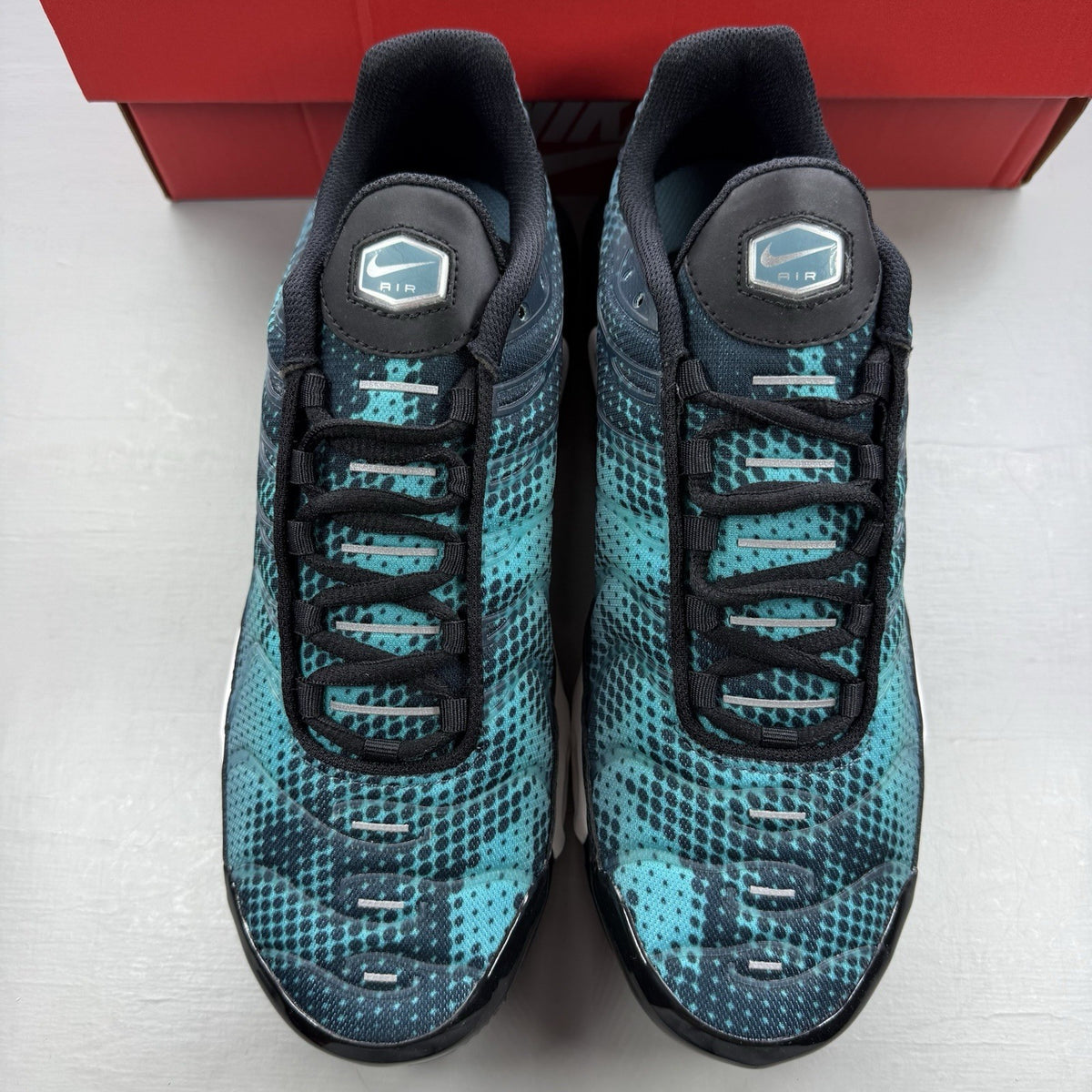 Nike Air Max Plus TN black with dusty cactus dot pattern and signature logo.