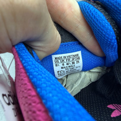 Adidas ZX Flux trainers in shock pink with black and blue accents, mesh upper.