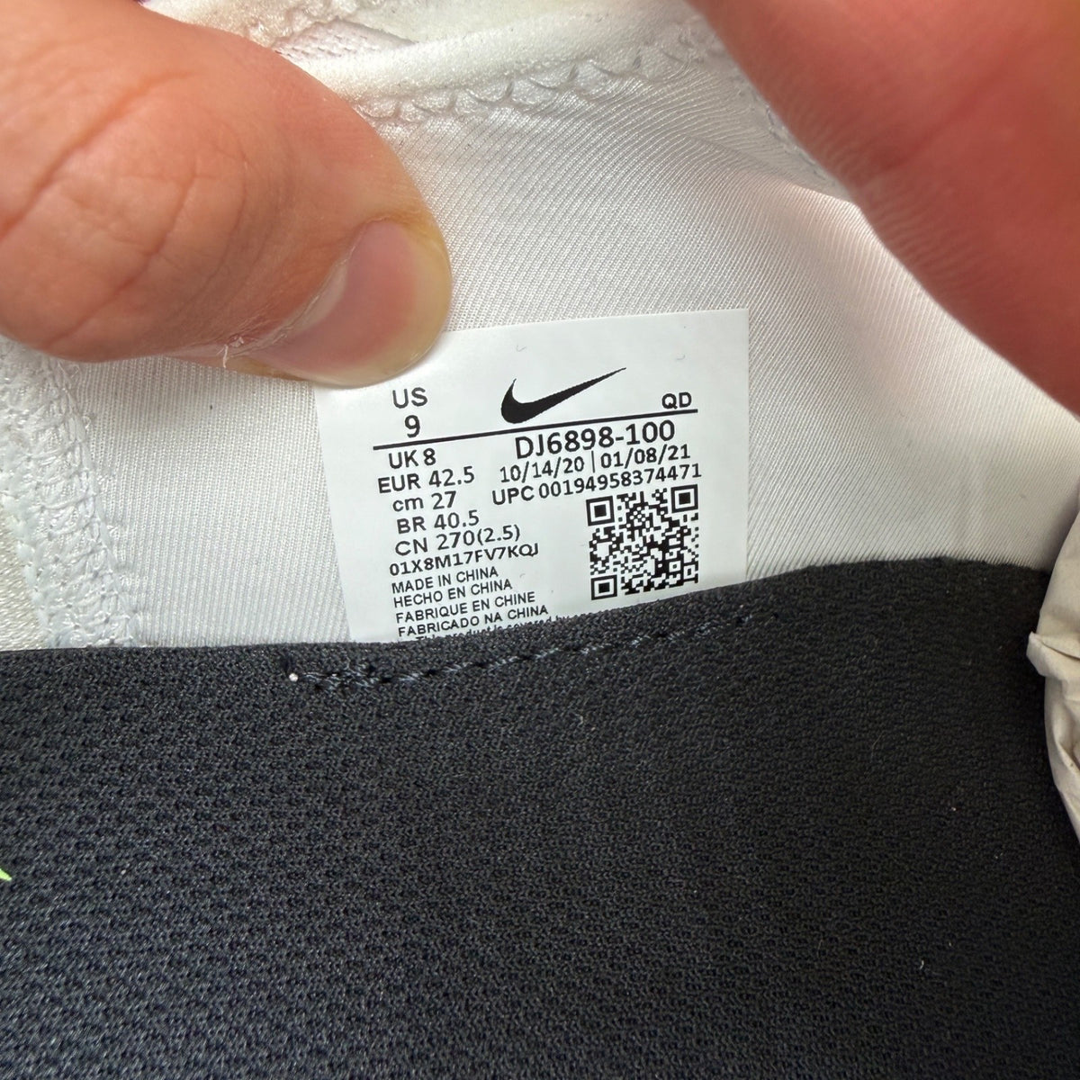 Nike white trainers with aquamarine and lime glow accents, featuring iconic logo details.