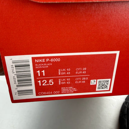 Nike black trainers with mesh upper and signature swoosh logo.