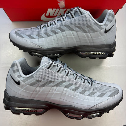 Nike Air Max 95 grey trainers with caution strip detailing and black accents.