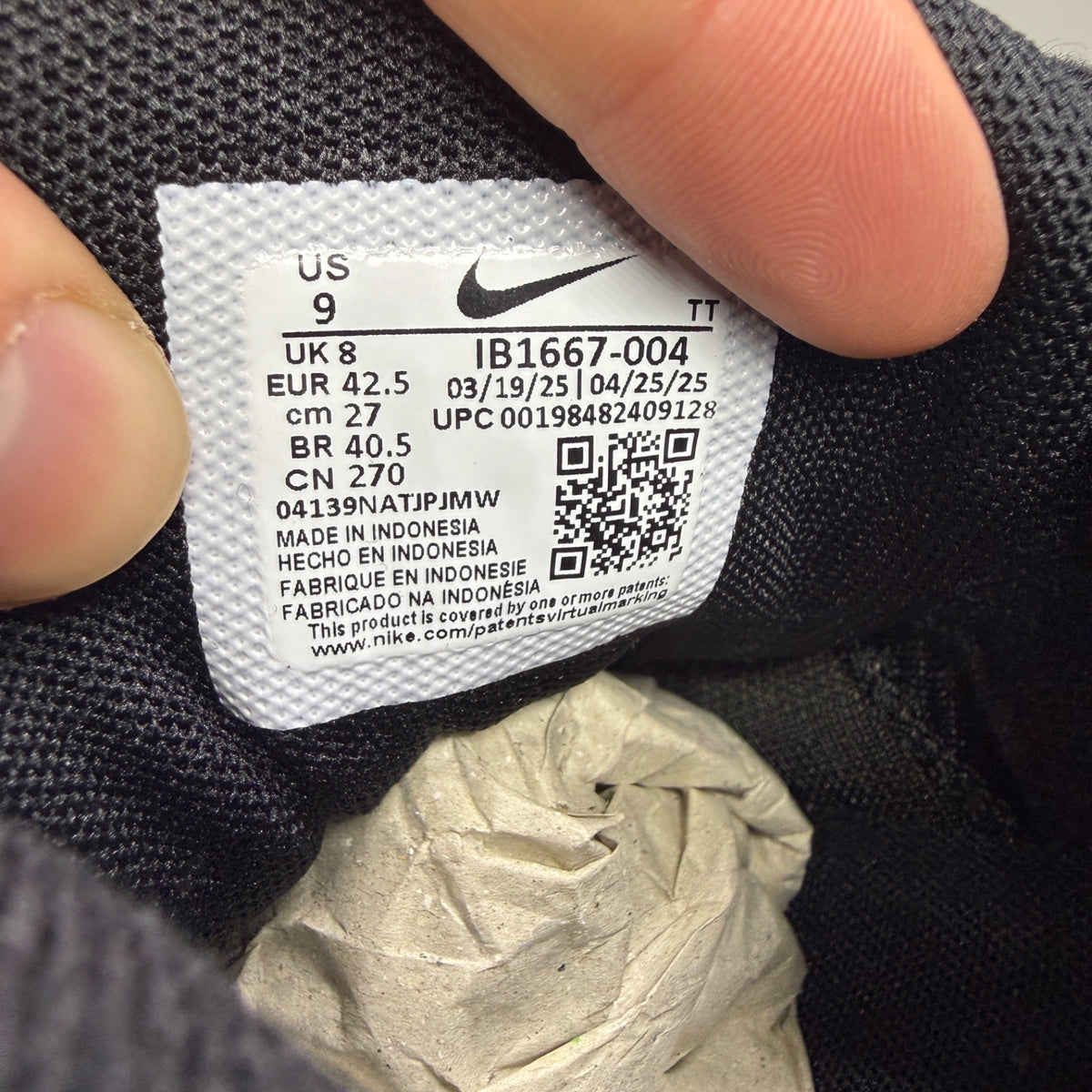 Nike running shoes black with smokey blue accents and visible Air Max cushioning.