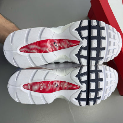 Nike Air Max 95 white sneakers with signature big bubble sole and logo detail.