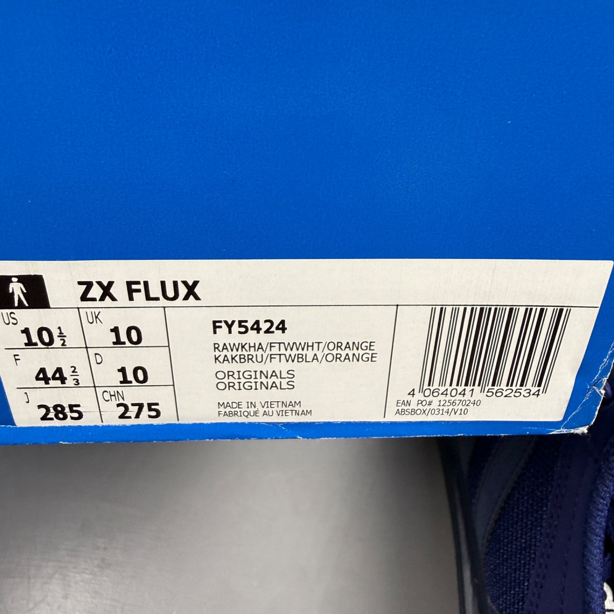 Adidas blue trainers with black accents and signature three-stripe logo.