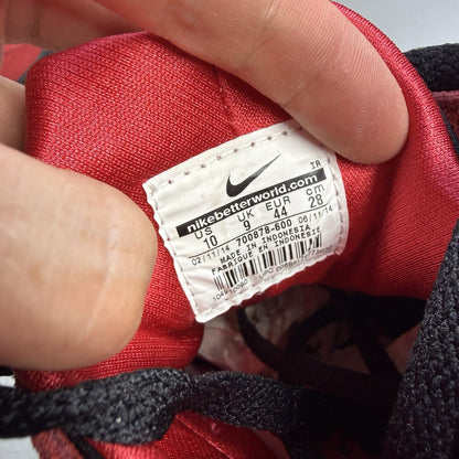 Nike Air Huarache trainers red and black with distinctive logo and unique design details.