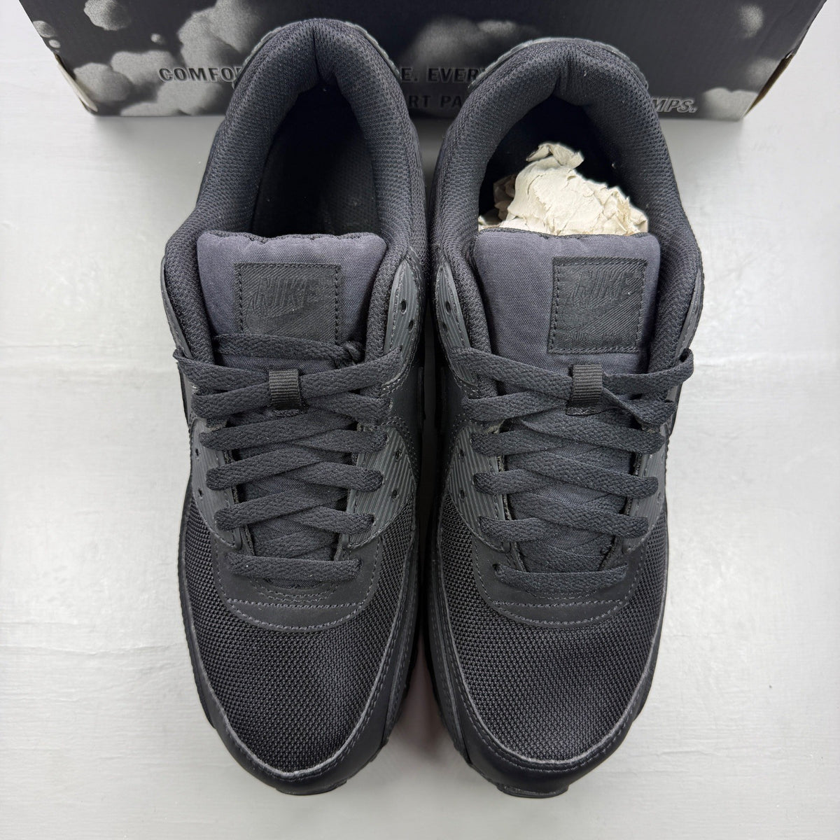 Nike trainers black with Air Max cushioning and signature swoosh logo.