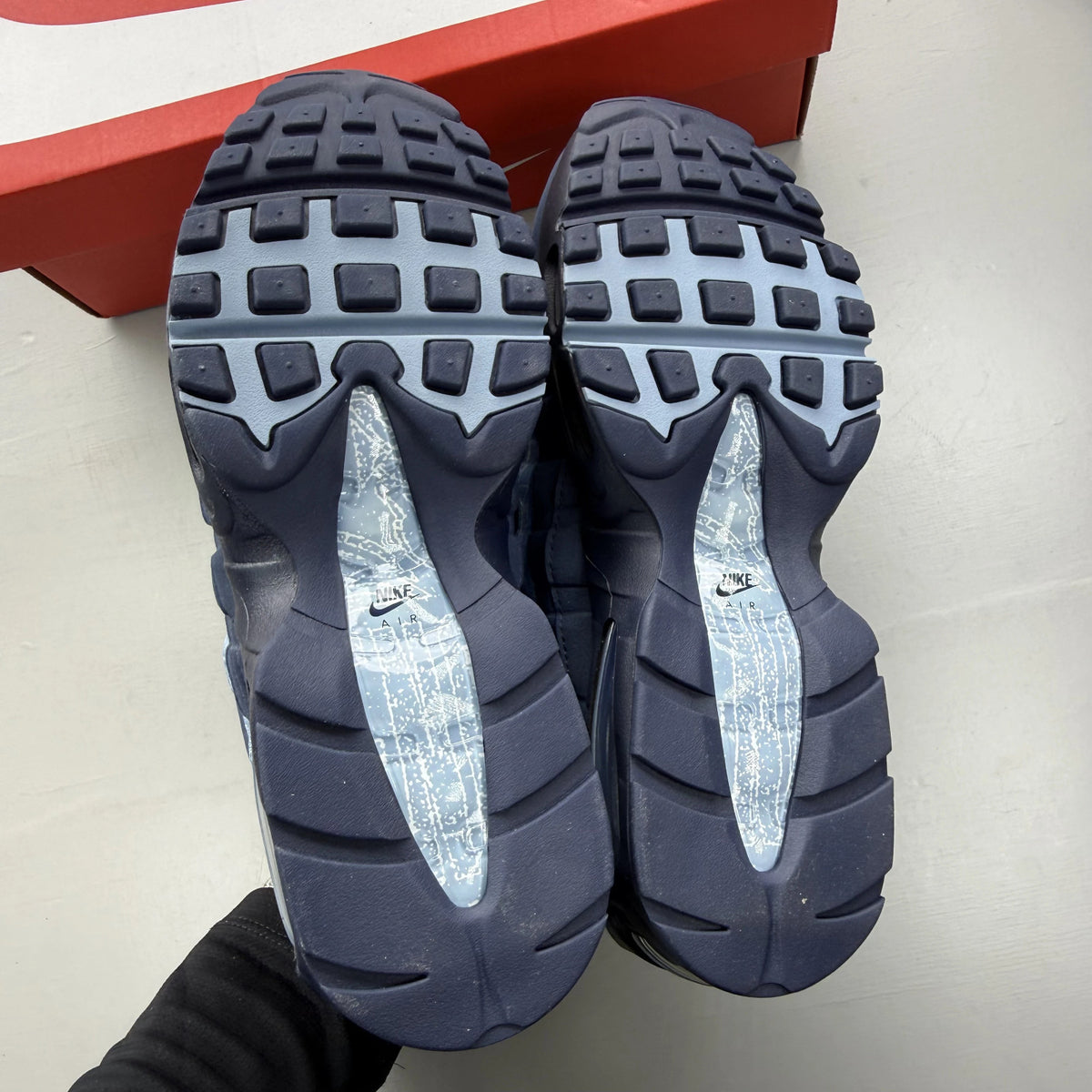 Nike Air Max 95 blue trainers with big bubble sole and branded logo details.