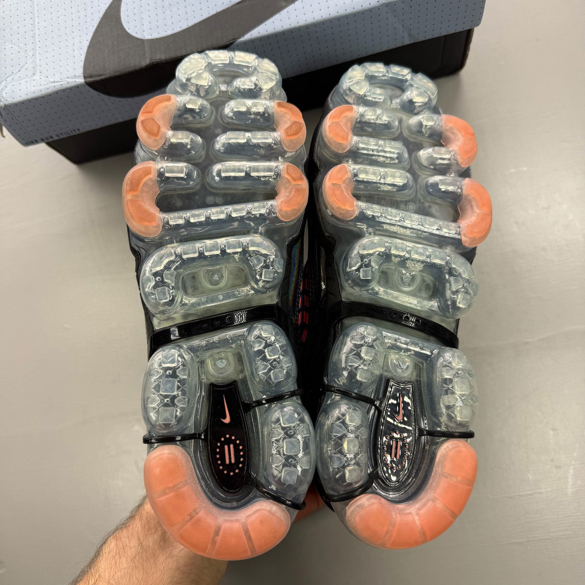 Nike Air VaporMax 360 red trainers with black accents and unique air sole design.