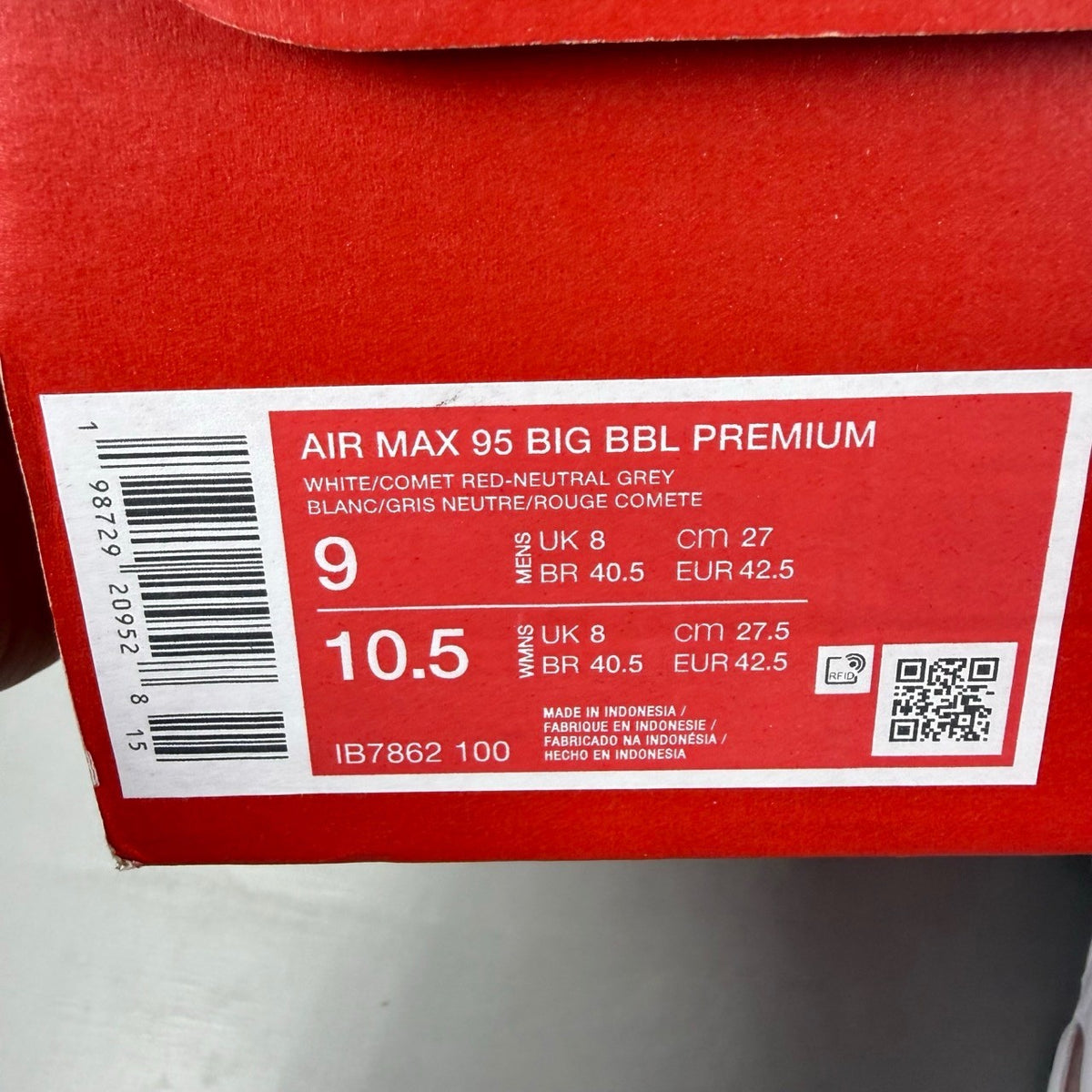 Nike trainers white with red accents and iconic Air Max bubble sole.