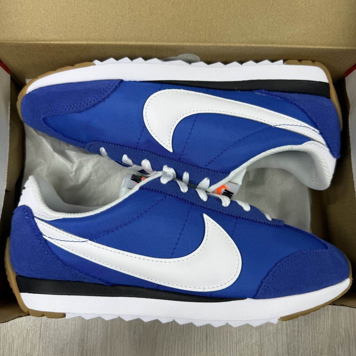 Nike blue trainers with white swoosh logo and mesh upper details.