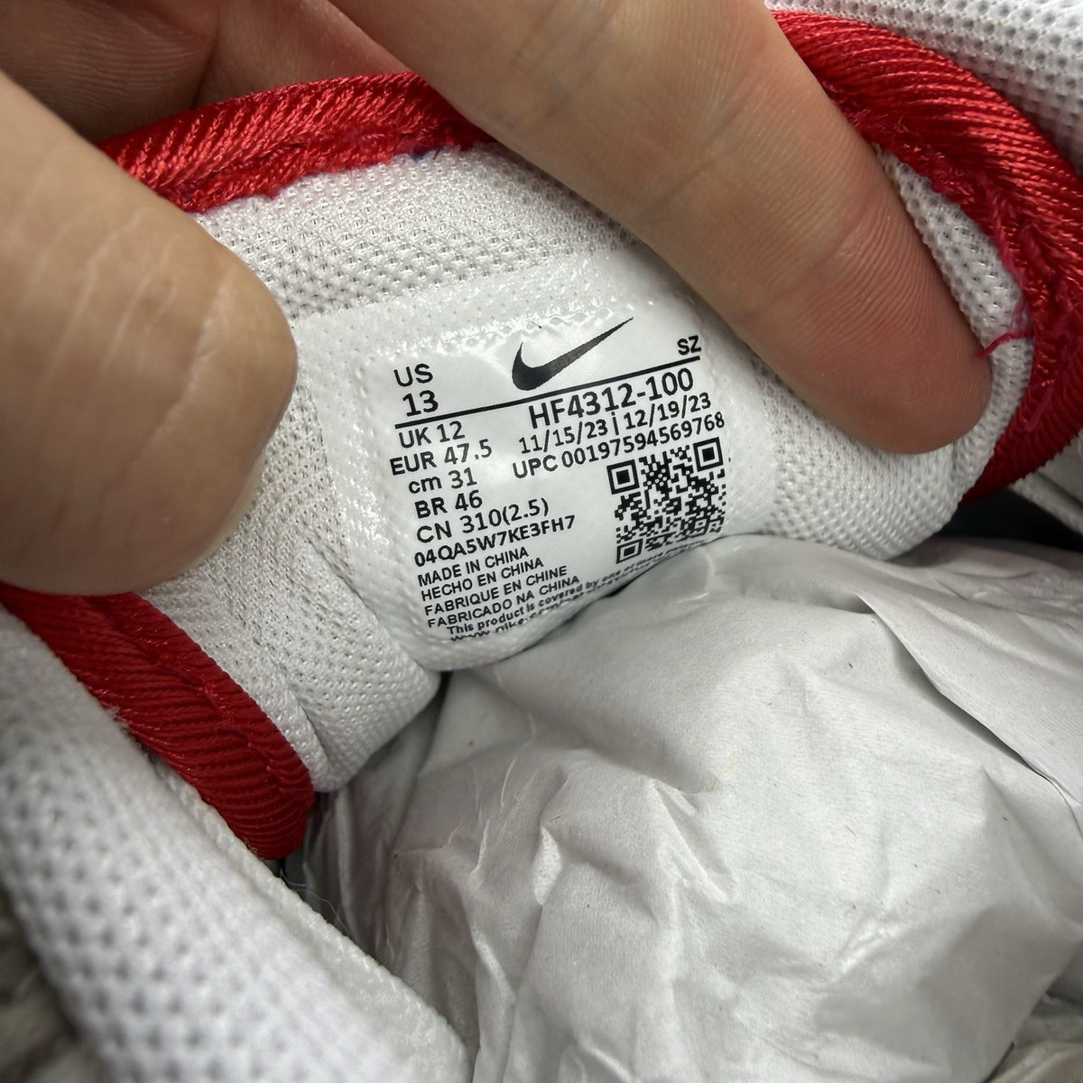 Nike Air Max 1 trainers white with university red accents and cream detailing.