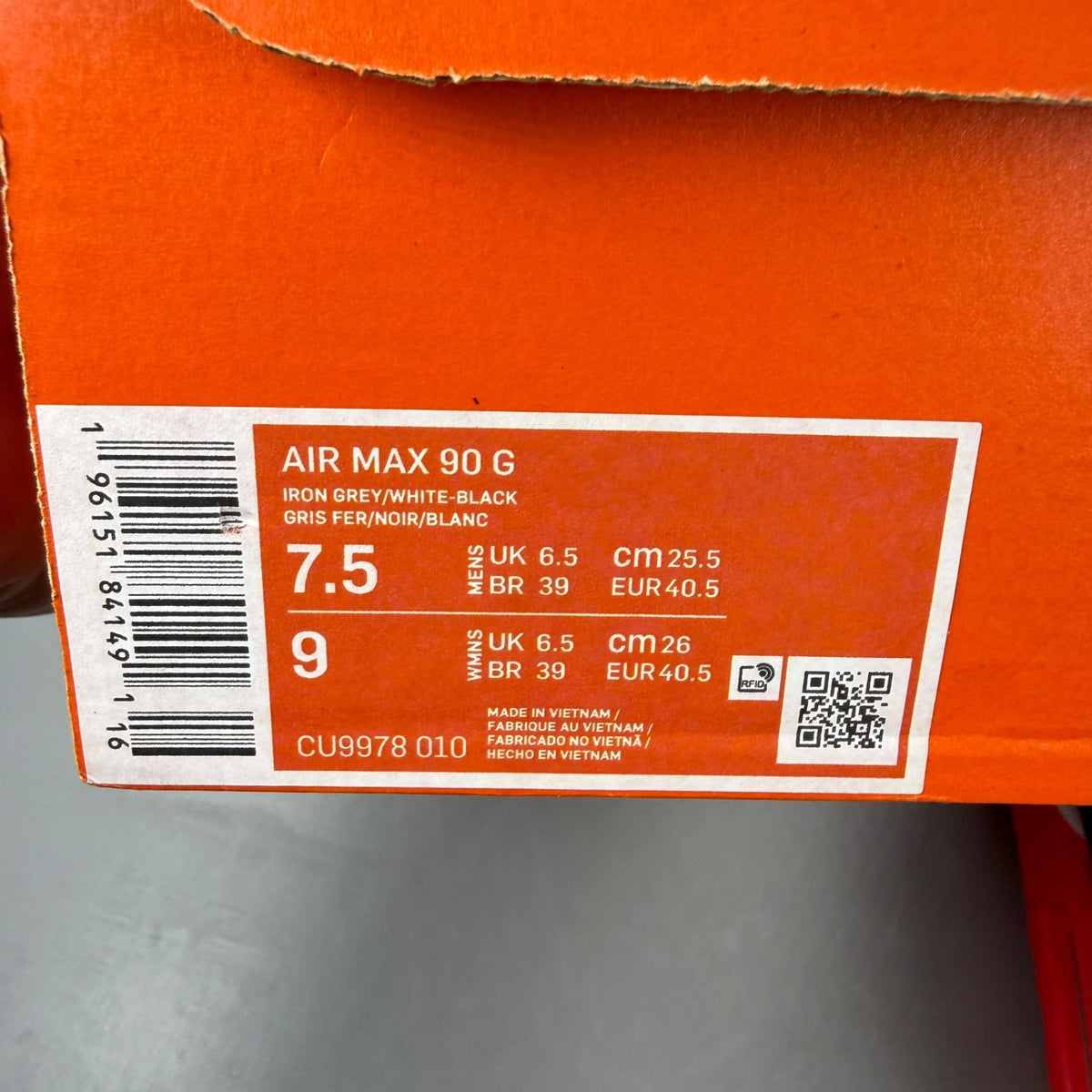Nike trainers black with infrared accents and grey detailing, featuring Air Max cushioning.