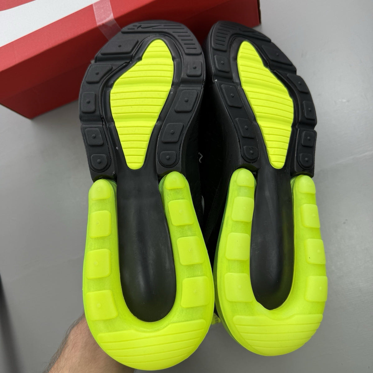 Nike Air Max 270 black trainers with neon volt accents and white sole.