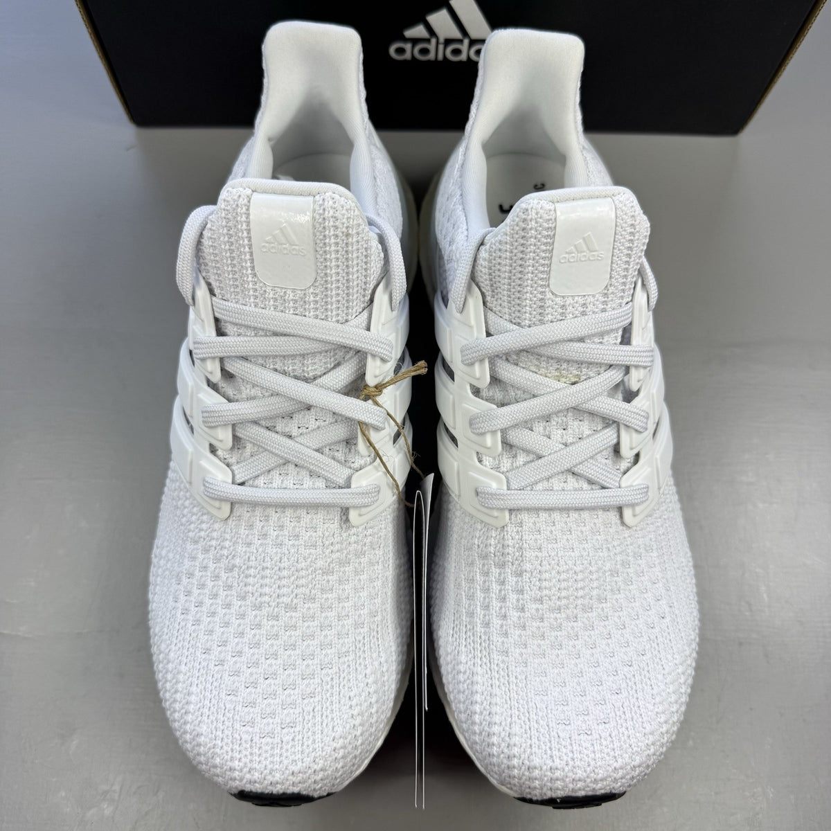 Adidas men's sneakers white with black accents and signature three-stripe logo.