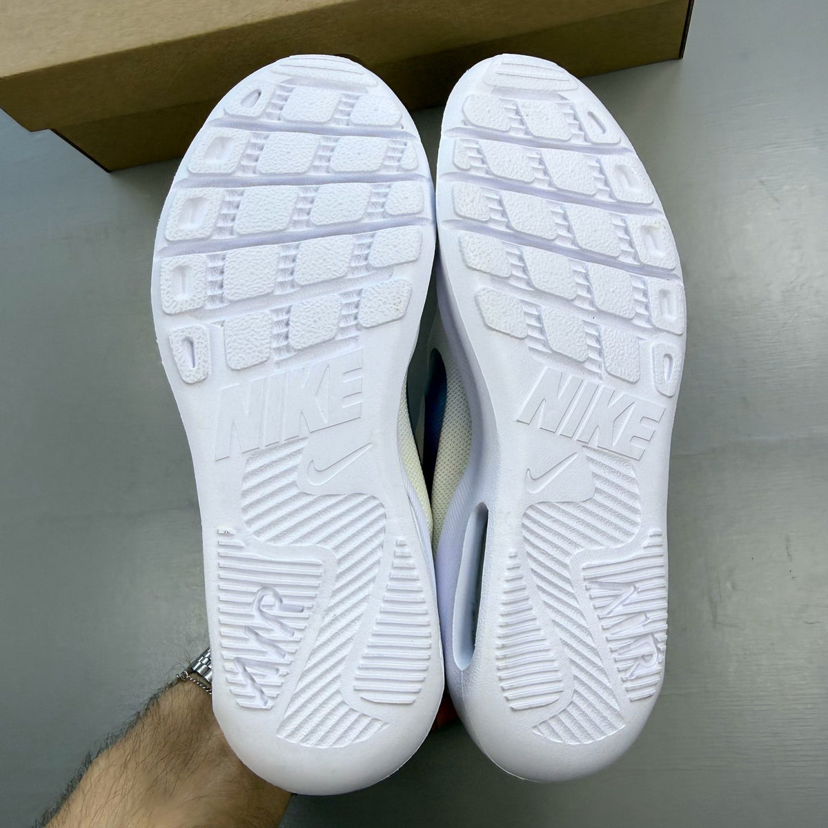 Nike Air Max Oketo white trainers with bubble pack design and logo detail.