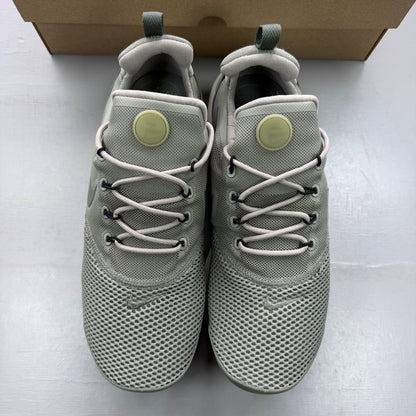 Nike trainers khaki green mesh upper with white sole and logo details.
