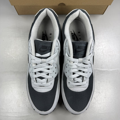 Nike trainers light smoke grey with black accents and iconic swoosh logo.