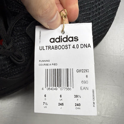 Adidas black trainers with grey accents and signature three-stripe logo.