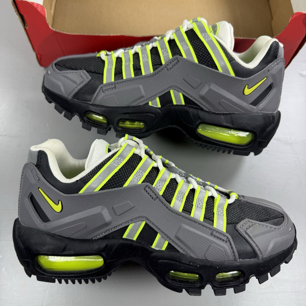 Nike NDSTRKT Air Max 95 black trainers with neon accents and textured material.