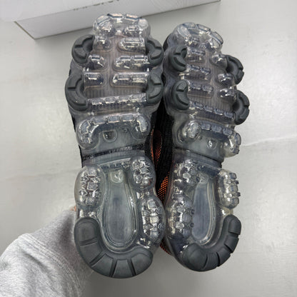 Nike Air VaporMax Flyknit 3 black trainers with total orange accents and breathable knit material.