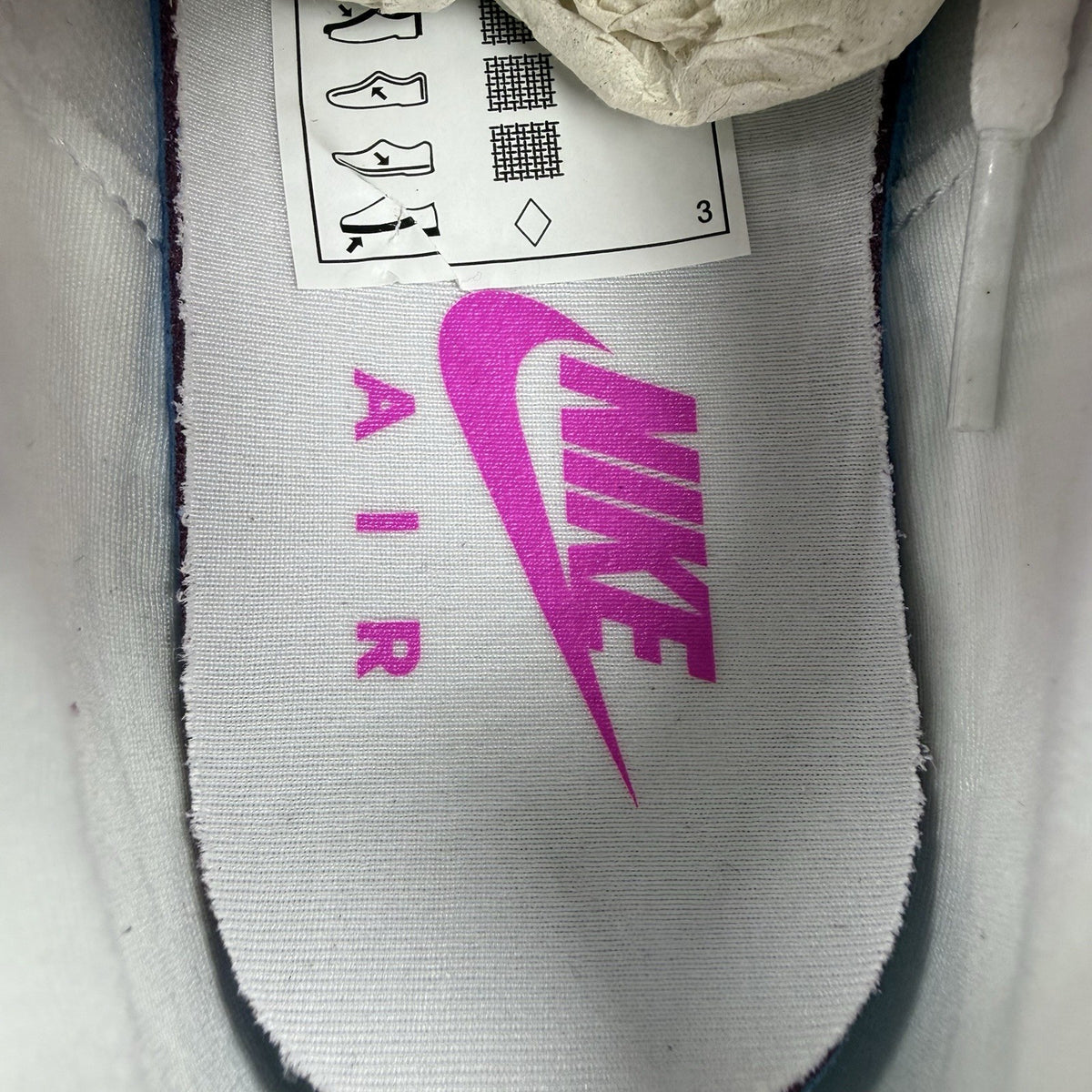 Nike Air Max Plus TN white trainers with fire pink foam fade and logo detailing.