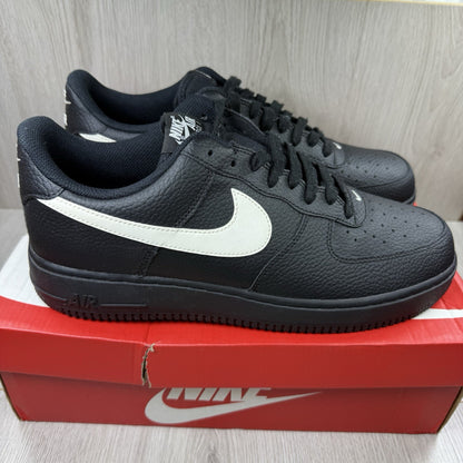 Nike Air Force 1 Low trainers black with white swoosh logo and sail accents.