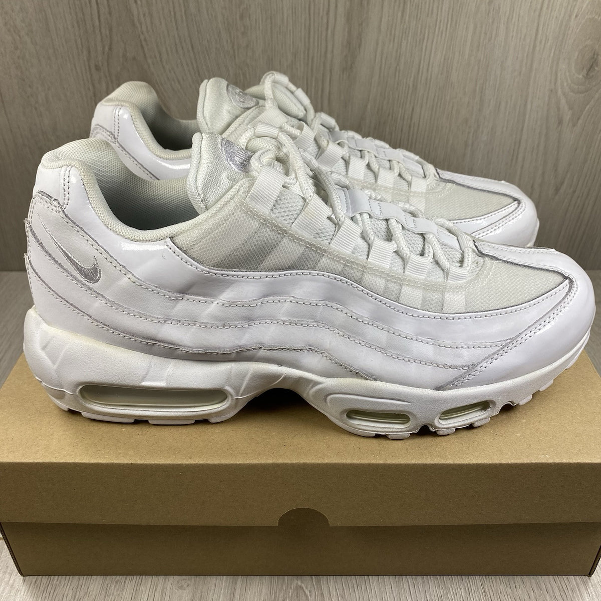 Nike Air Max 95 trainers white mesh upper with signature swoosh logo and layered design.