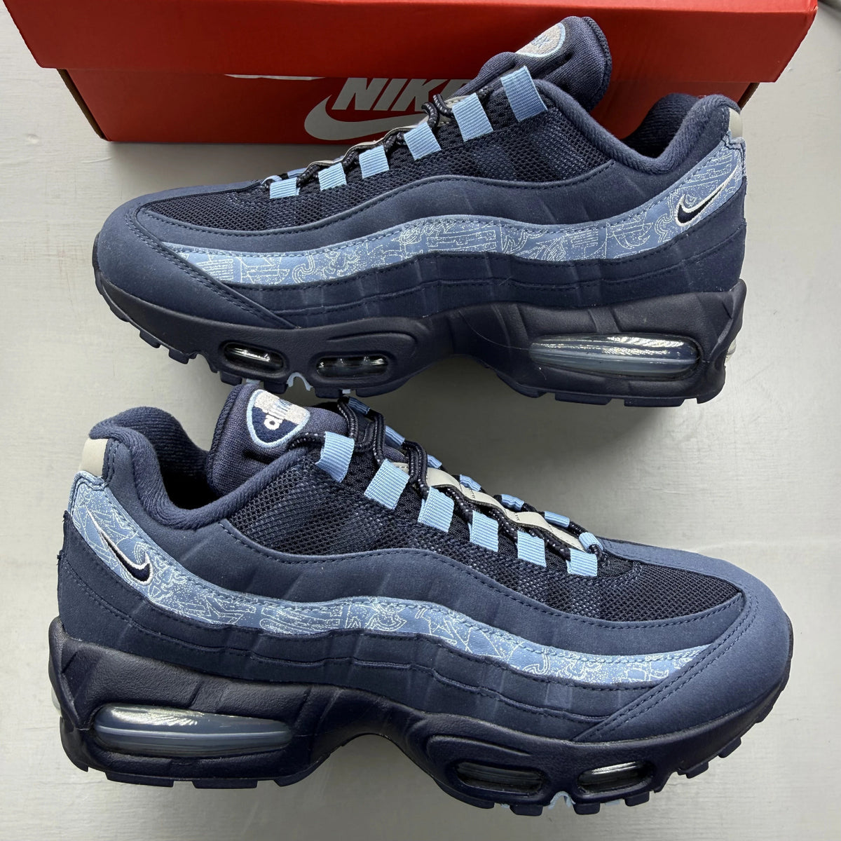 Nike Air Max 95 blue trainers with big bubble sole and branded logo details.