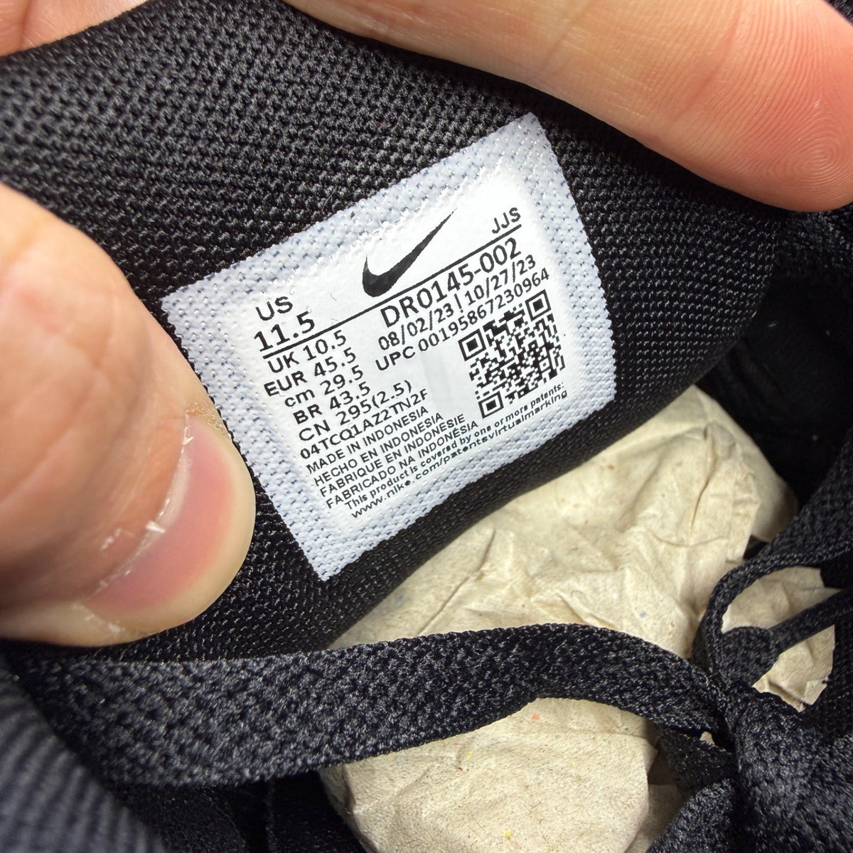 Nike running shoes black with grey accents and logo on the side.