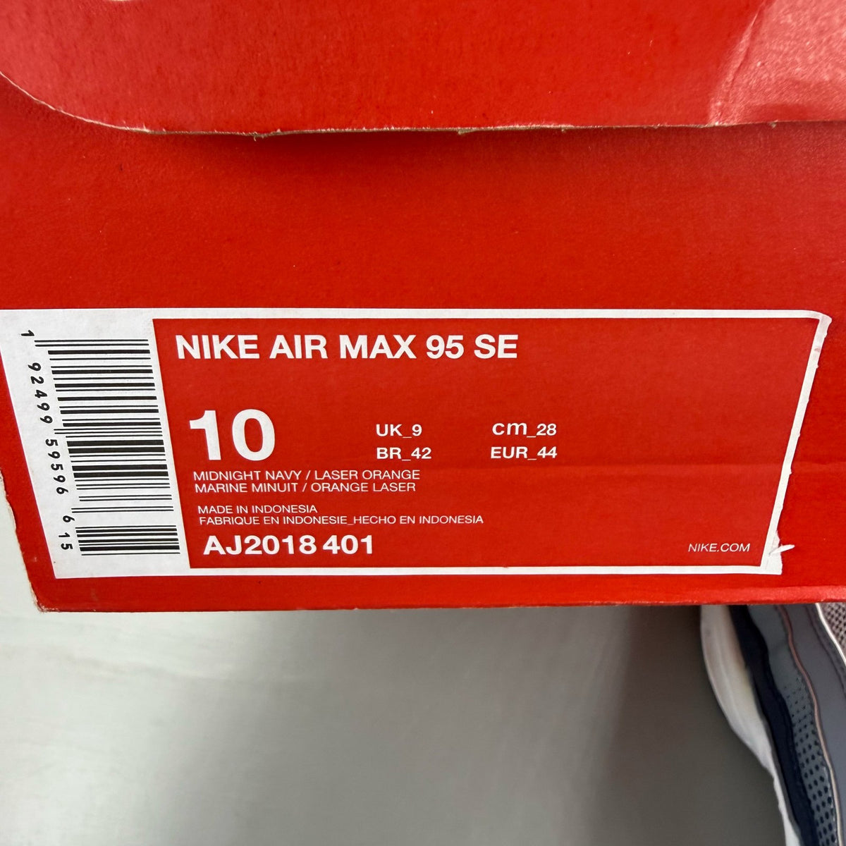 Nike Air Max 95 white trainers with midnight navy and laser orange accents.