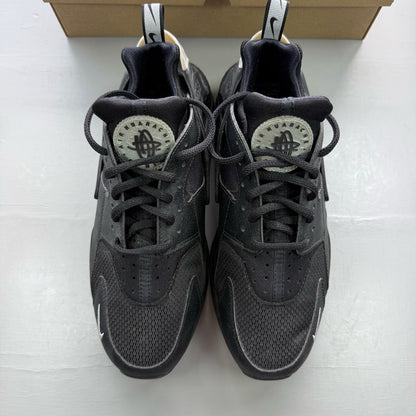 Nike black Air Huarache trainers with metallic silver mini swoosh logo.