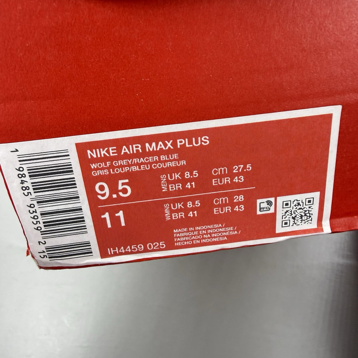 Nike Air Max Plus TN trainers grey with blue accents and signature swoosh logo.