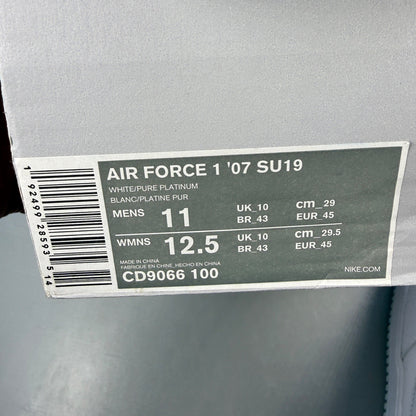 Nike Air Force 1 white trainers with pure platinum grey accents and classic logo.