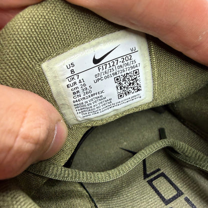 Nike green trainers with breathable mesh upper and cushioned sole.