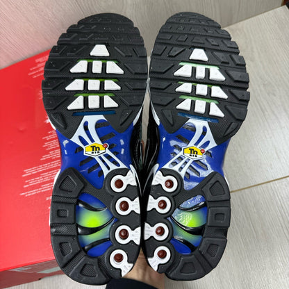 Nike Air Max Plus TN trainers black with racer blue and volt accents, mesh material.
