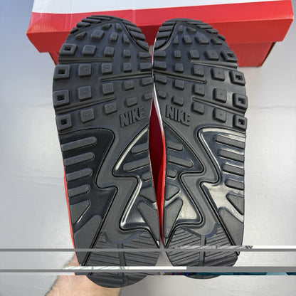 Nike Air Max 90 red trainers with white accents and signature swoosh logo.