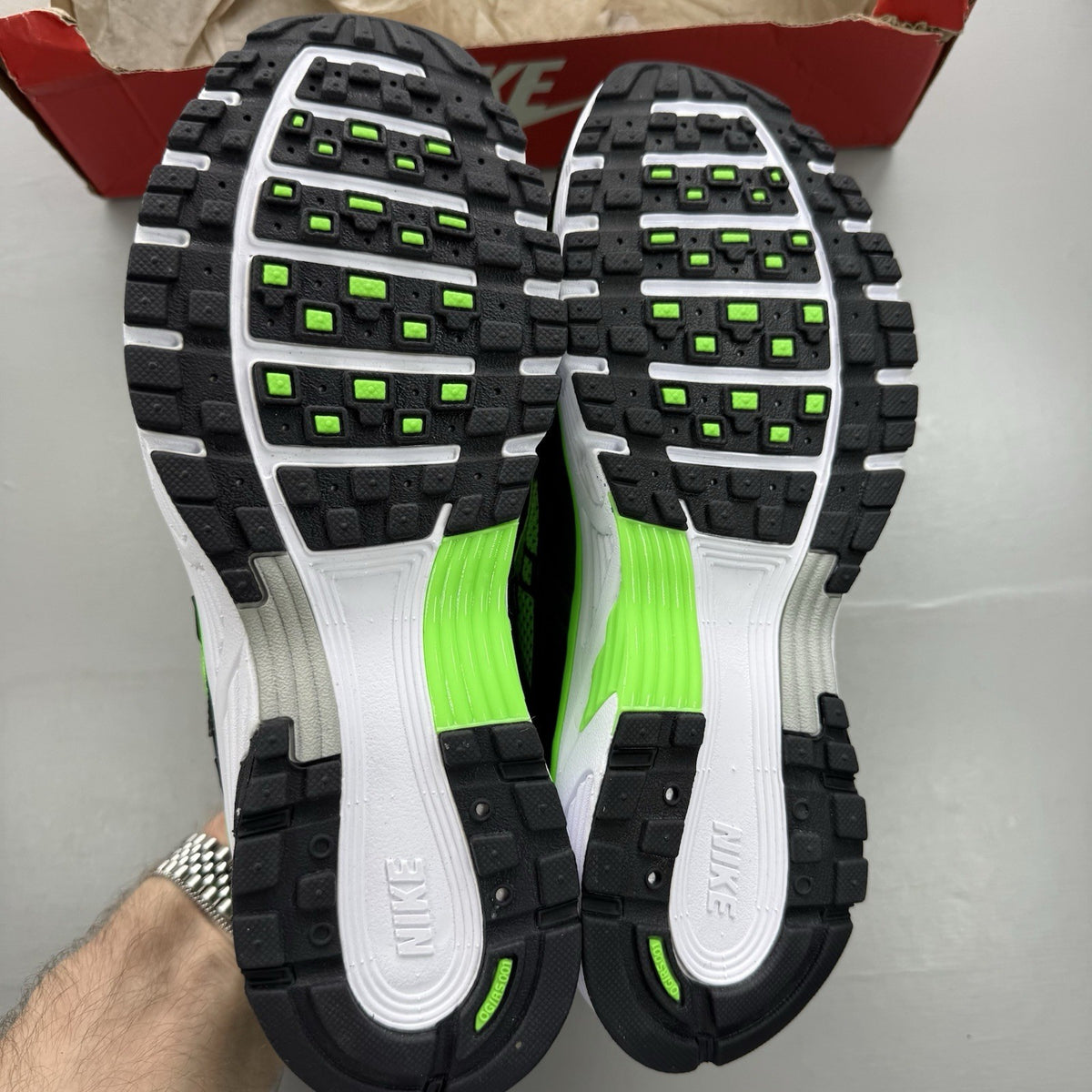 Nike P-6000 trainers black with green and white accents, mesh and synthetic material.