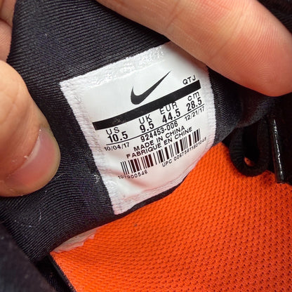 Nike athletic shoes orange with black accents and Air VaporMax sole design.