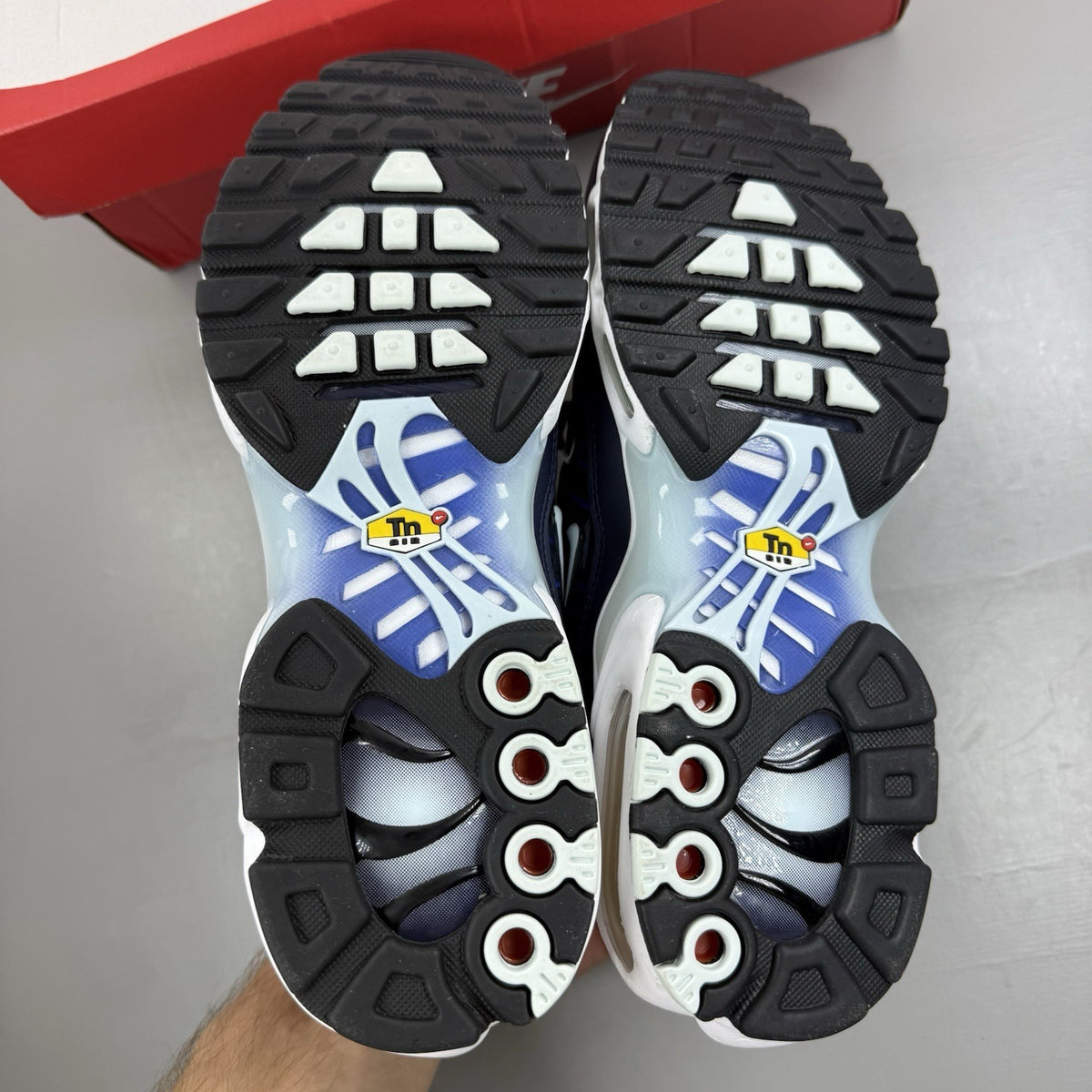 Nike Air Max Plus trainers navy blue with signature swoosh logo and mesh detailing.
