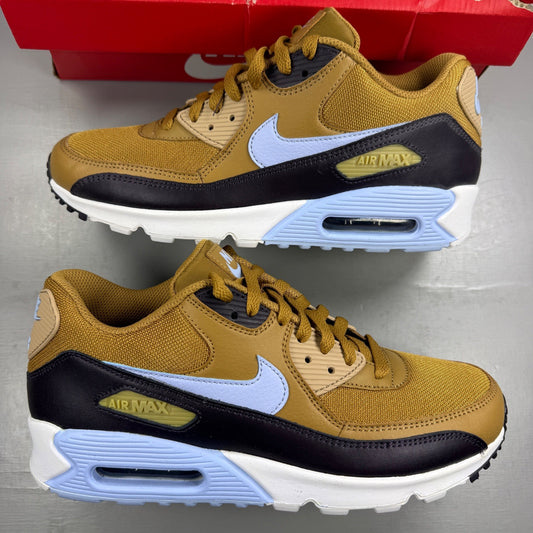 Nike black trainers with muted bronze accents and Air Max cushioning design.