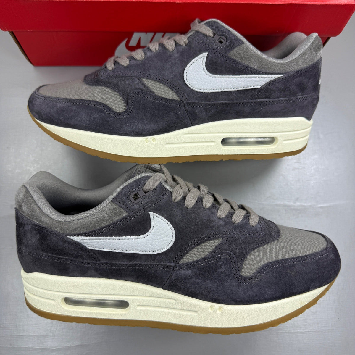 Nike grey deck shoes with premium crepe sole and logo detailing.