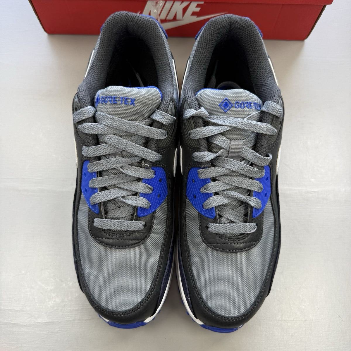 Nike Air Max 90 trainers cool grey with blue accents and Gore-Tex material.
